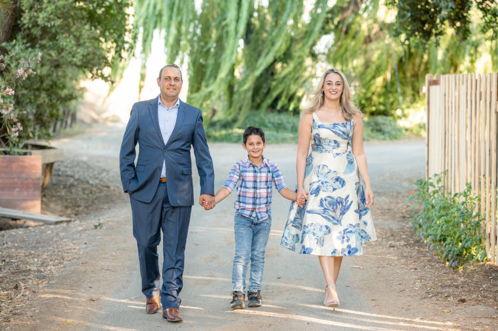 Family of three walking at photo shoot at West 12 Ranch with Gia Chong Photography, Lodi CA photographer