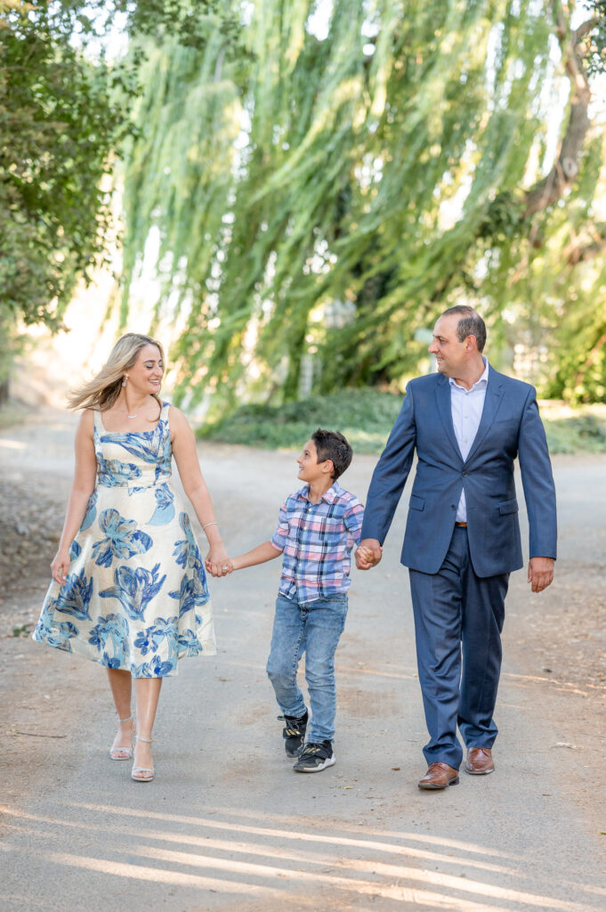 Family of three walking at family photo session at West 12 Ranch with Gia Chong Photography, Lodi CA photographer