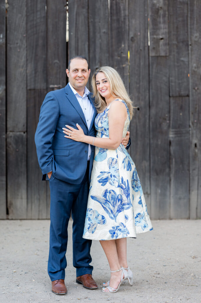 Mom and dad in front of barn doors at a shoot at West 12 Ranch with Gia Chong Photography, Lodi CA photographer