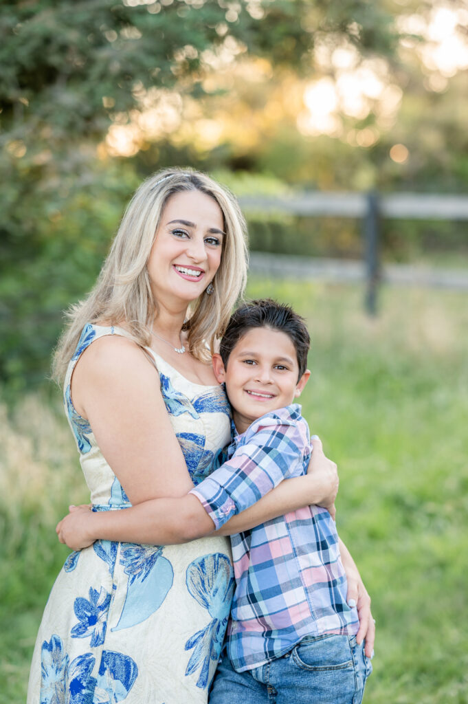 Mom and son hugging at a field at a family shoot at West 12 Ranch with Gia Chong Photography, Lodi CA photographer