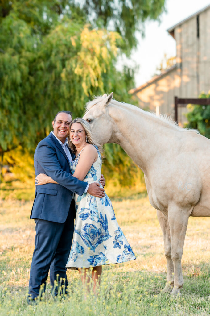 Mom and dad laughing at the photo bomber horse their shoot at West 12 Ranch with Gia Chong Photography, Lodi CA photographer