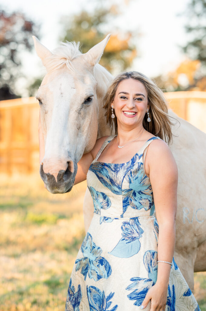Woman posing with a horse during her family photo session at West 12 Ranch with Gia Chong Photography, Lodi CA photographer