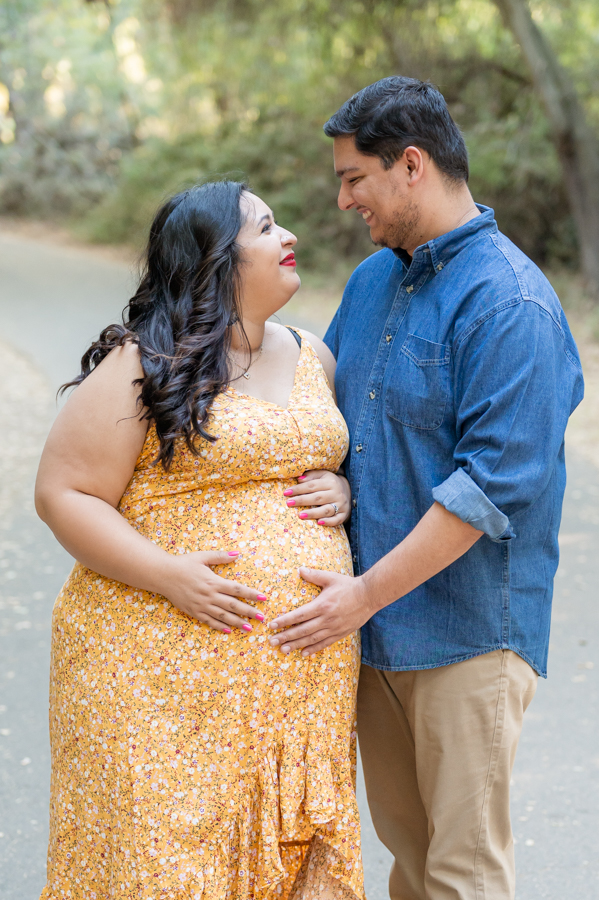Dad and pregnant mom posing on a nature trail during a maternity session at Lodi Lake Park, Lodi CA with Gia Chong Photography, Lodi Photographer