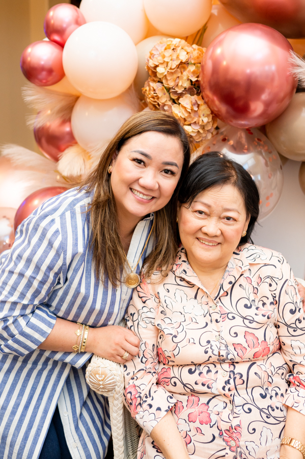 Mother and daughter posing in a balloon decorated room during a birthday party photographed by Gia Chong Photography in Stockton, California.