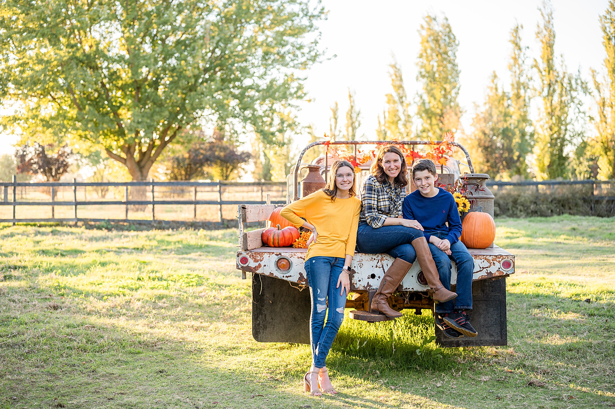 family seated on a truck fall pose idea