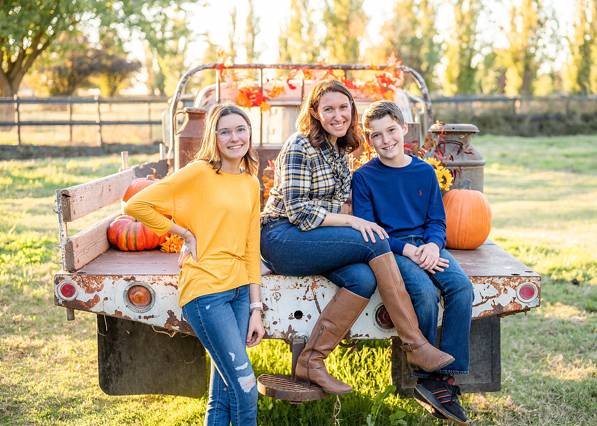 family seated on a truck fall pose idea