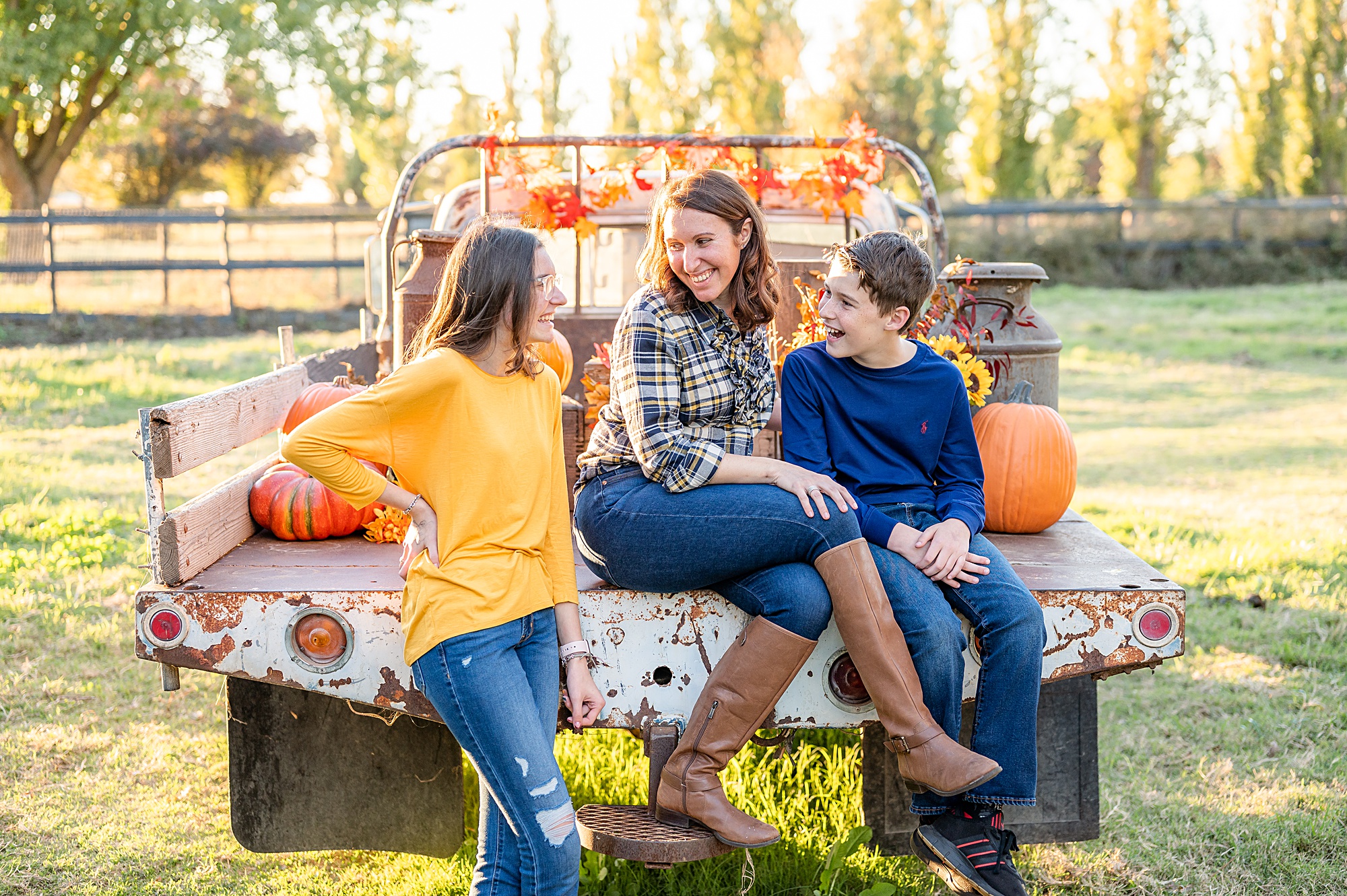 family seated on a truck fall pose idea