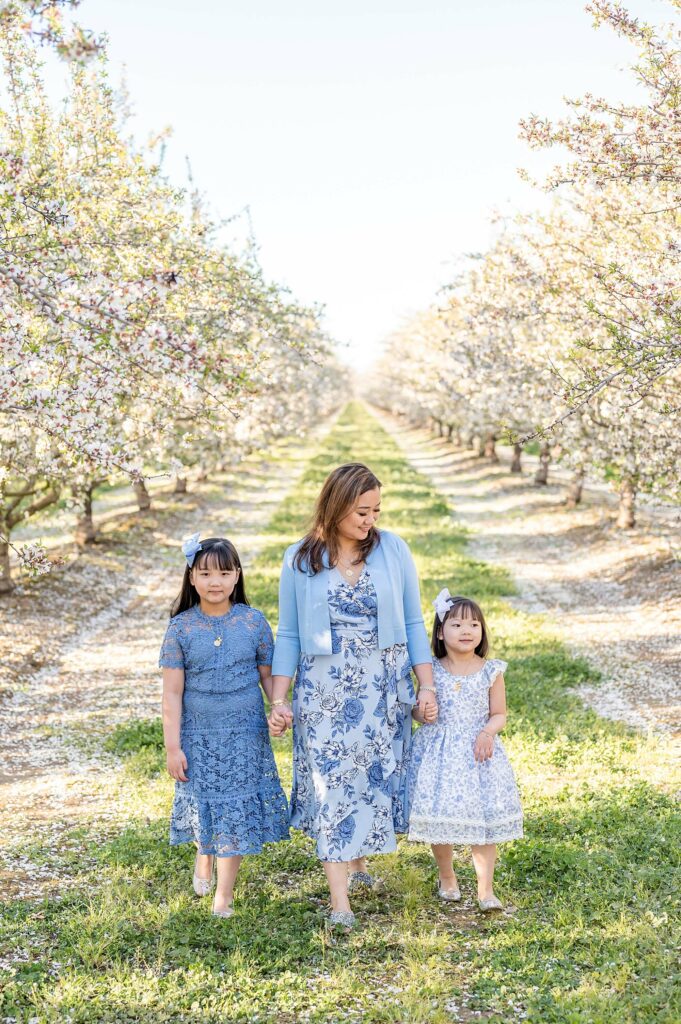 Mom and daughters walking pose idea almond blossoms photo session