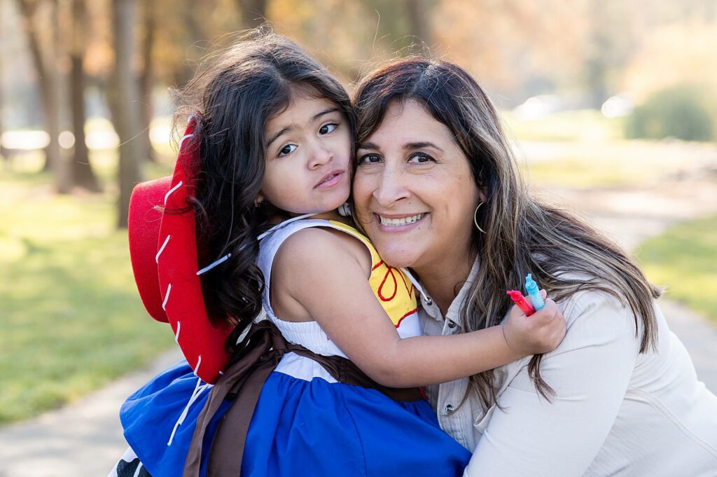 Little girl and grandma hugging during toy story inspired photo shoot