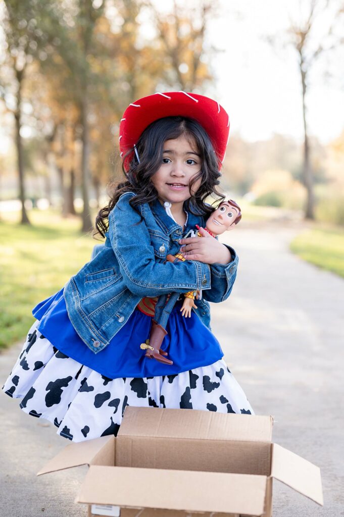 Little cowgirl with Woody posing during toy story inspired photo shoot