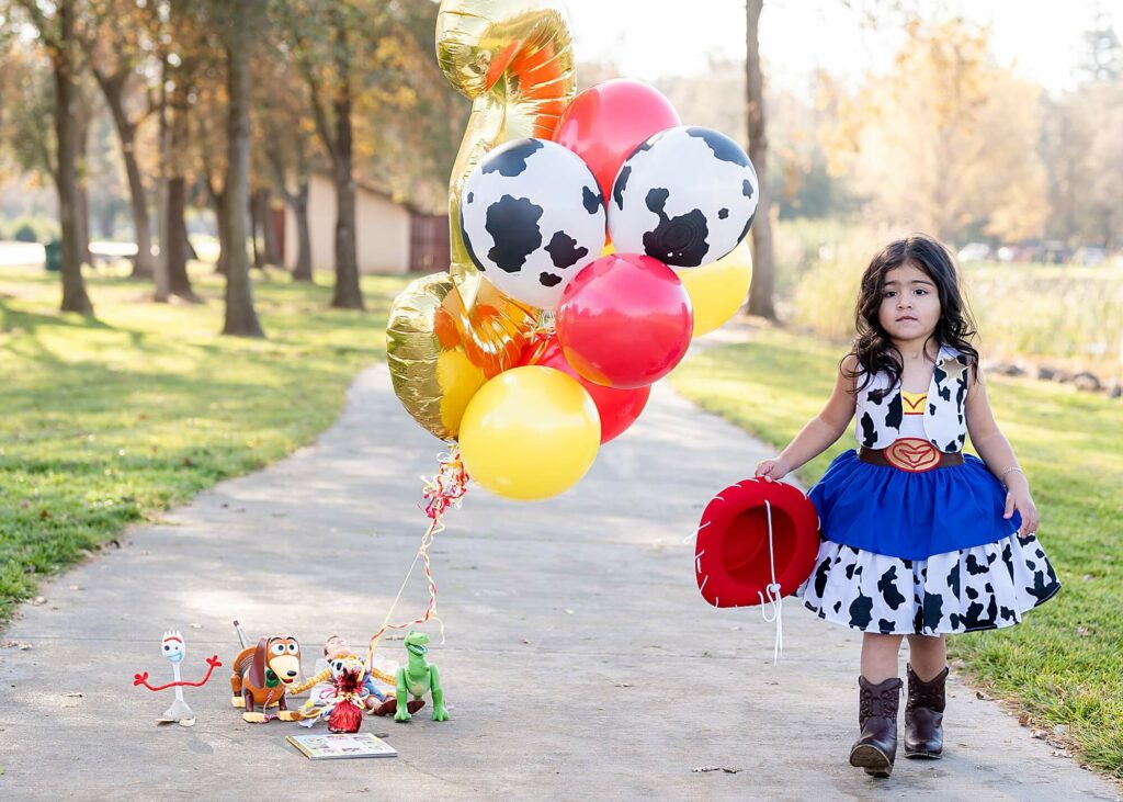 Little girl walking away from toys during toy story inspired phot shoot