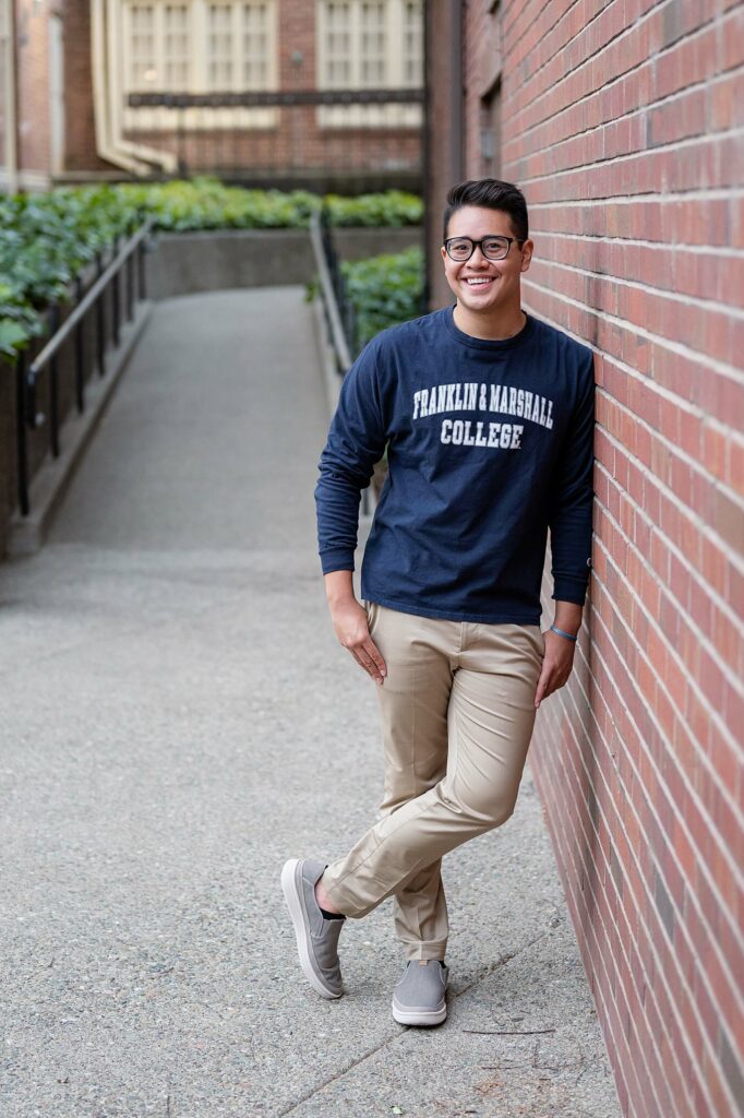 male leaning on wall pose idea