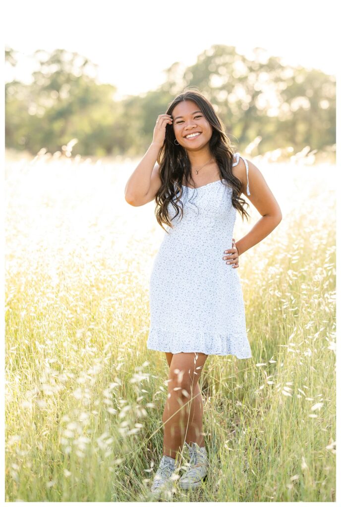 Senior girl standing pose idea during outdoor family photo session