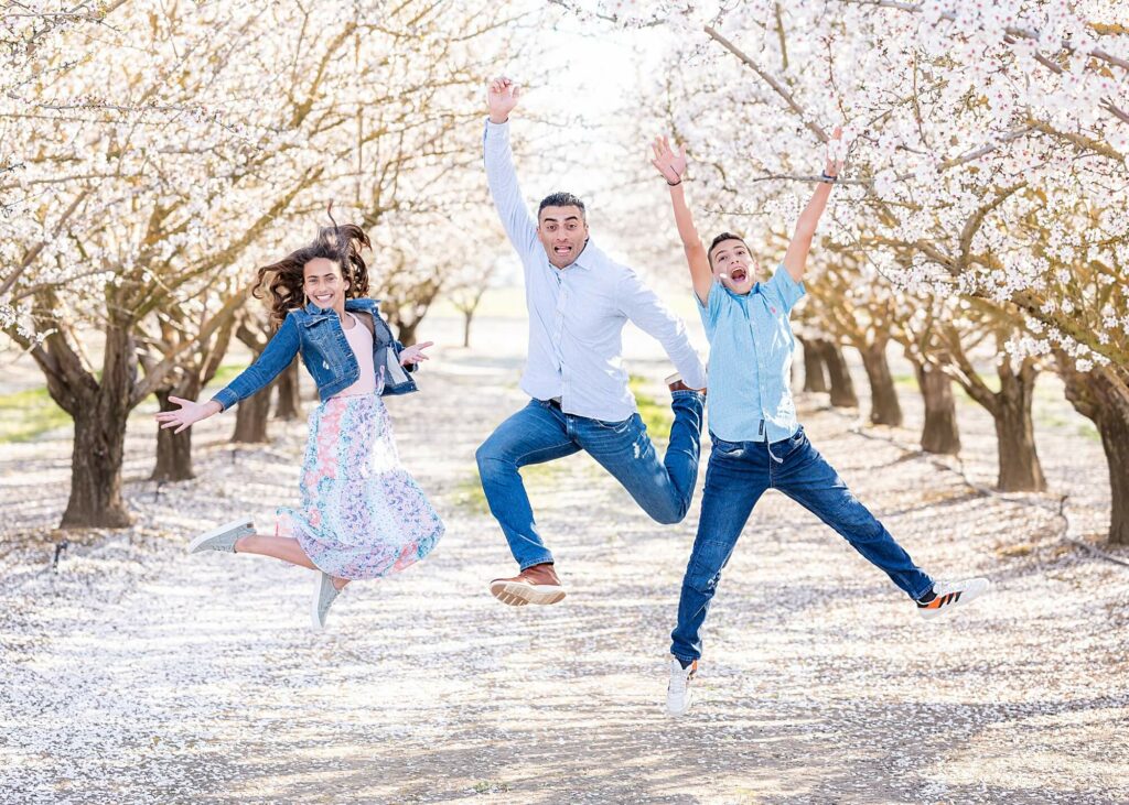 family jump pose almond blossom photo shoot