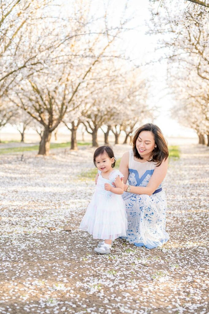 mom and daughter at an almond orchard