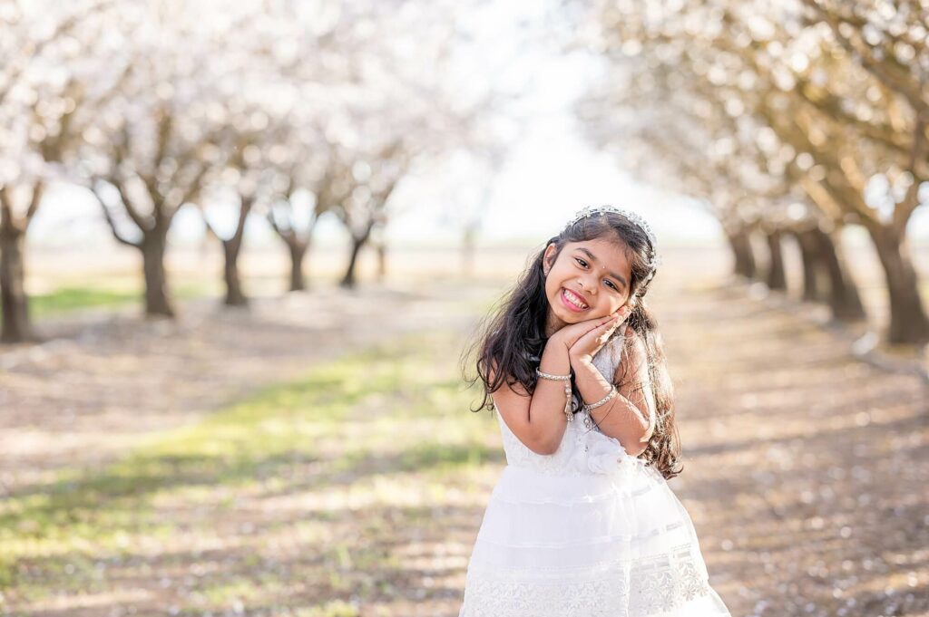 little girl posing during almond blossom photoshoot