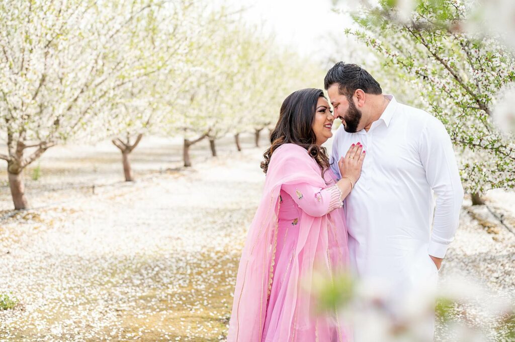 romantic engagement pose during almond blossom photoshoot