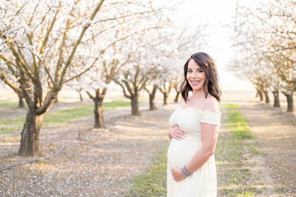 mom holding belly for maternity shoot