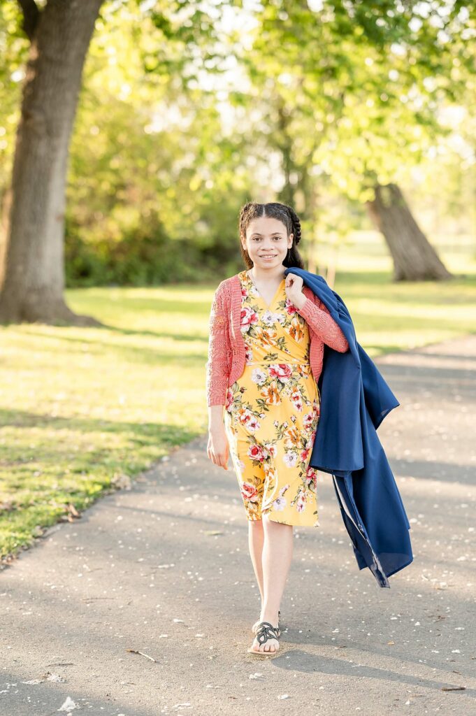 8th grade graduate walking with gown posing idea