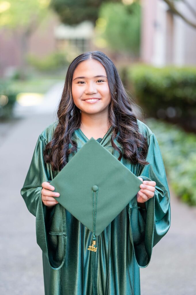 grad posing with graduation cap