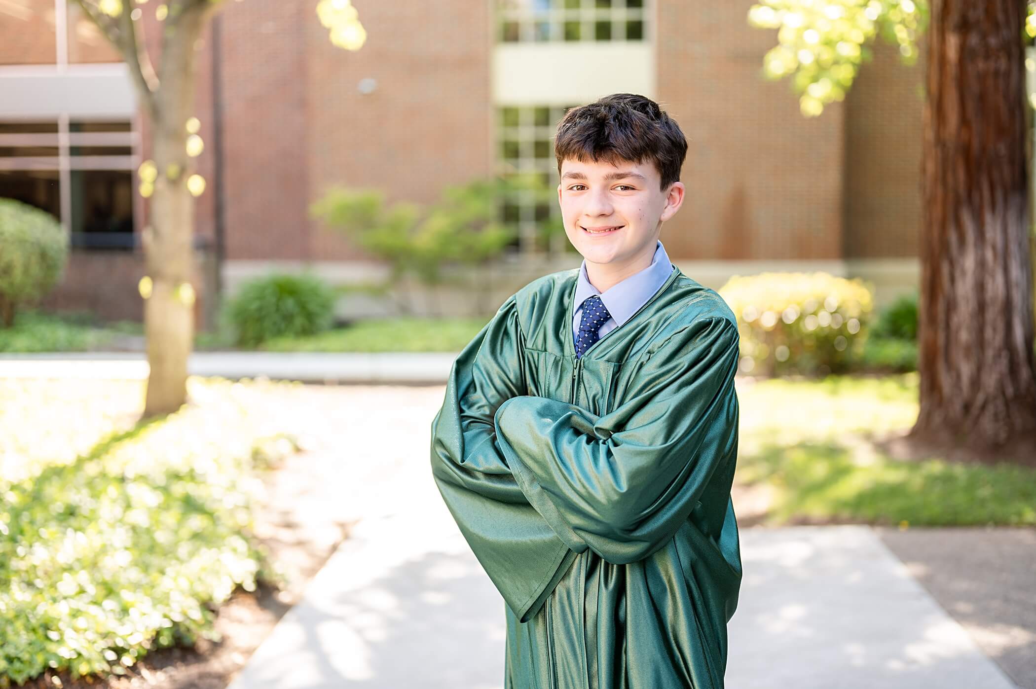 graduating boy in grad gown and smiling at the camera