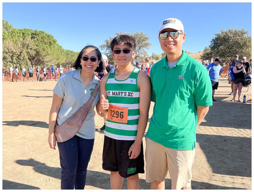 Family smiling at the camera during a cross country competition