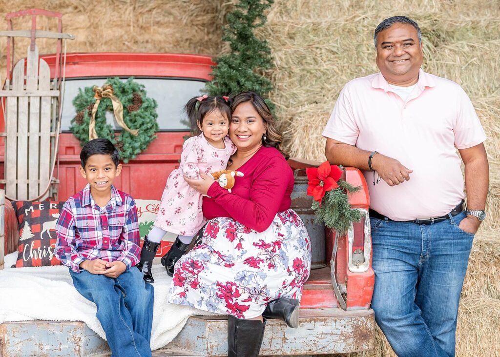 family smiling and looking at the camera