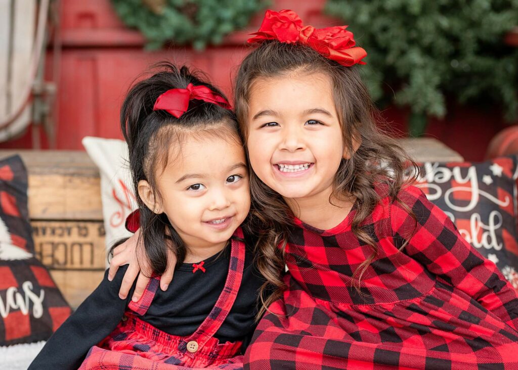 posing idea sisters hugging and smiling at the camera 