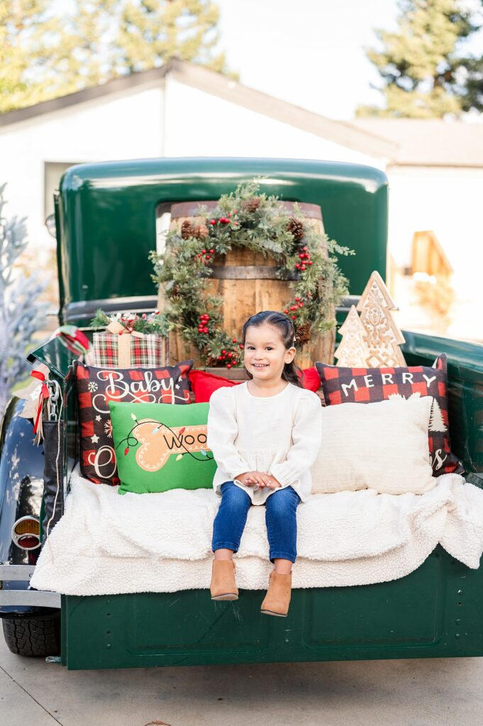Little girl smiling at the camera during a Vintage Truck Christmas Mini Session near Lodi CA