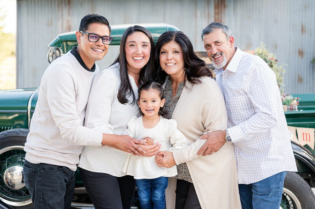 family hugging and smiling at the camera during a holiday mini session