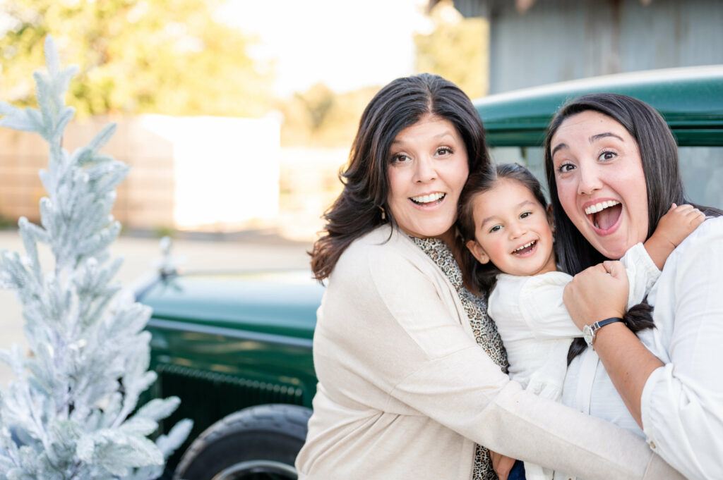 Grandma, grand child and mom hugging during a Vintage Truck photo shoot