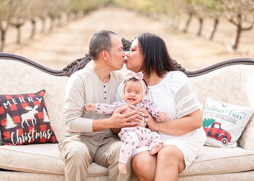 Parents kissing on Christmas Couch at Golden R Ranch Stockton CA