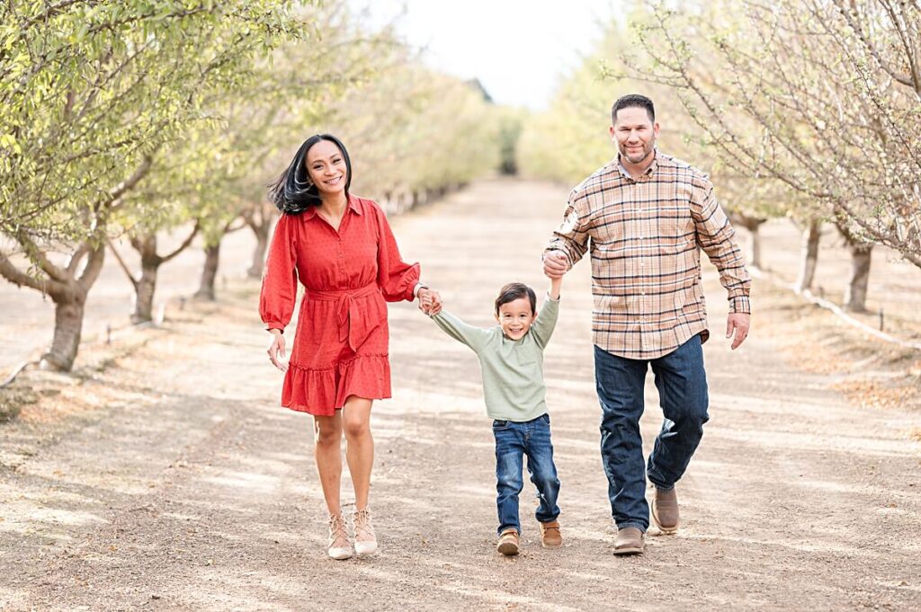 Family walking in an almond orchard at Golden R Ranch Stockton CA