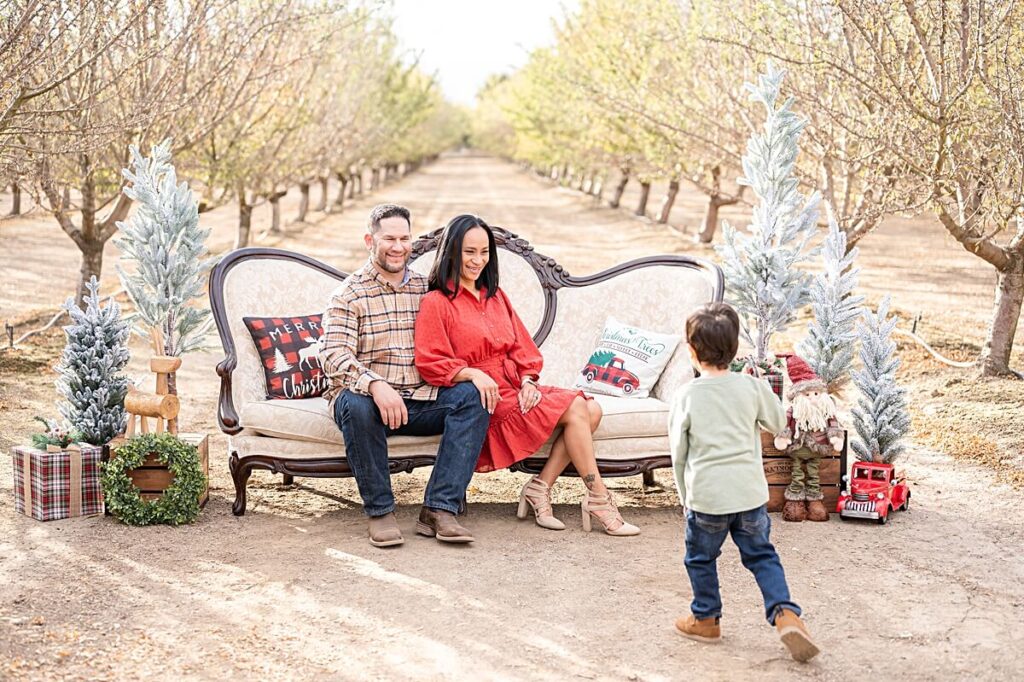 parents smiling at their son while on a Christmas Couch at Golden R Ranch Stockton CA