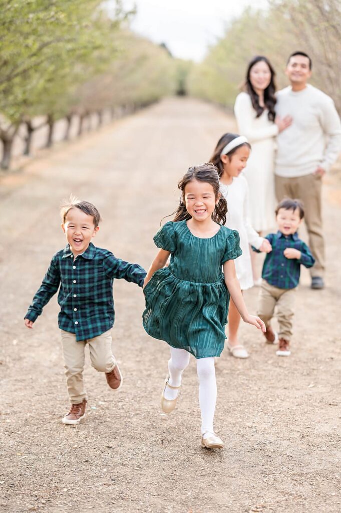 Kids running at an almond orchard in Golden R Ranch Stockton CA