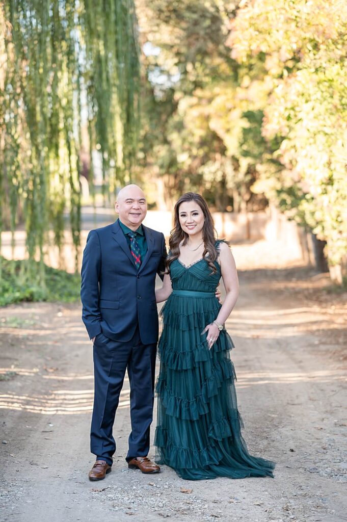 parents in formal clothes smiling at the camera at West 12 Ranch Lodi