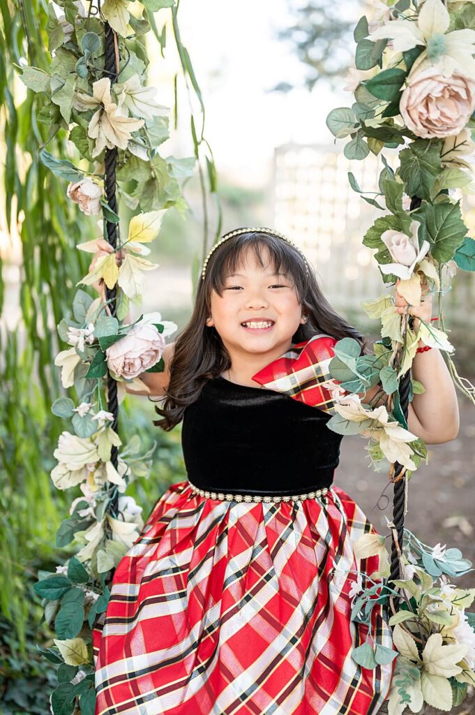 Little girl on a swing at West 12 ranch