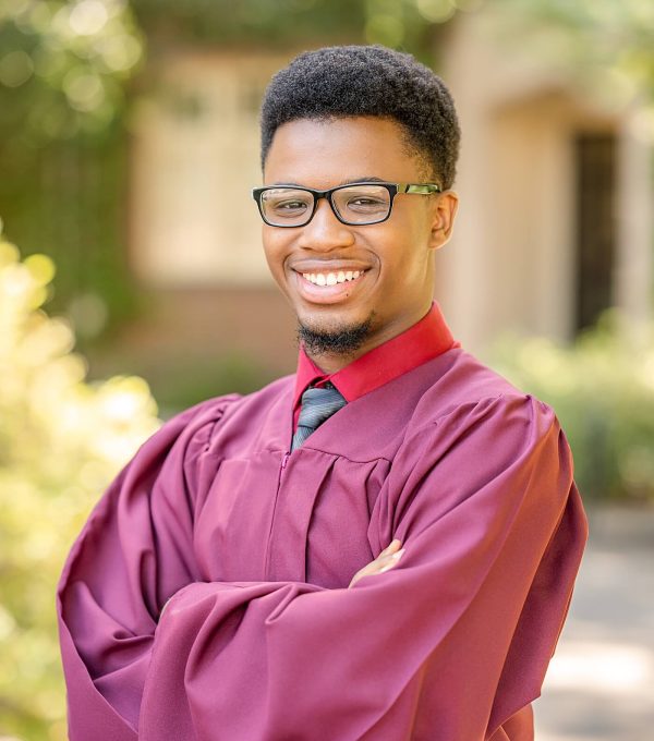 Senior Guy in grad gown arms crossed posing idea